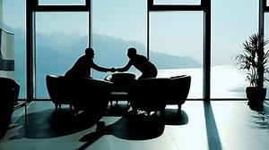 Two Young Business Partners Talking Inside Modern High Rise Office Building with Panoramic Window View