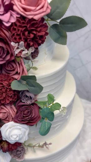1K views · 17 reactions | This tiered wedding cake is the perfect way to add a touch of elegance to your special day. The white and burgundy flowers add a delicate touch, and the tiers create a sense of height and drama. #weddingcake #tieredcake #whitecake #flowers #elegantcake #wedding #bride #groom #love #happy #beautiful #weddinginspiration #cakedecorating #baking #instacake #cakeoftheday | Palermo Bakery | Facebook