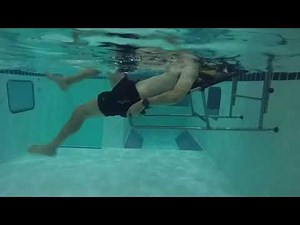 A patient exercising in the pool who suffers from Low Back Pain
