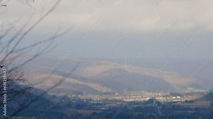 Olean 2x speed overcast sky mountain valley town from far away moving clouds, early winter cold overcast day.