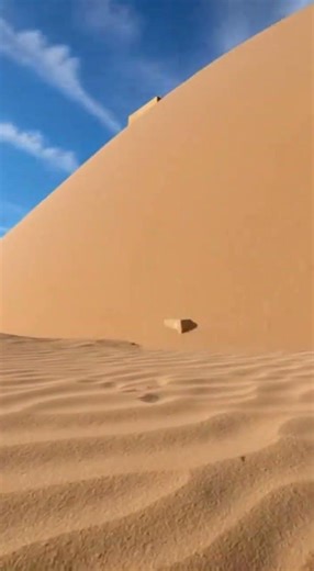 Time-lapse of pyramid being covered by sand over centuries, then being excavated