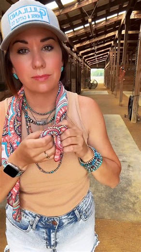 This summer tie for your wild rags has got to be the simplest! Roll it up with seams in and then tie a knot on one side. Makes it like a slide knot. #wildragtutorial #wildragaddict #westernoutfits #rodeooutfit #felrhat #tshirtdress | Gilliland H&C Ranch Wear