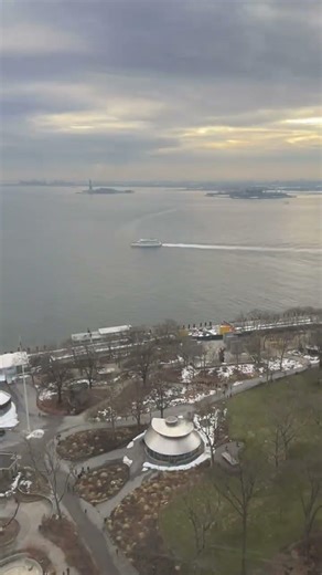 Cloudy sunset over NY harbor, Ellis Island and the Statue of Liberty, Manhattan, NYC, timelapse