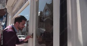 Shop owner opening up record, CD and hi-fi shop Stock Video