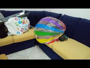 gigante beach ball deflating with an air pump[