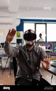 Professional man videographer making gestures with augmented reality headset, prosessing film montage in post production program. Video editor using high tech office VR modeling software application Stock Photo - Alamy