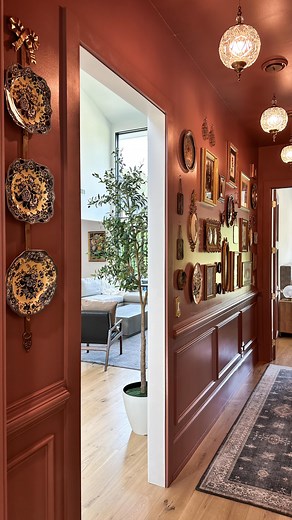 Before and after of the hallway makeover! I’m loving my first ever gallery wall, custom fabric art, thrifted decor all against the beautiful Reddened Earth by @hgtvhomebysherwinwilliams! Comment SHOP if you want links to anything or shop my LTK! | Lutz Go Home