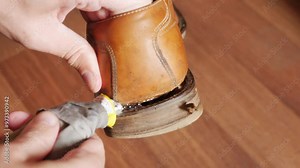 Repairing the soles of old shoes using glue close-up Stock Video