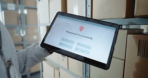 clip-3694243701-inventory-manager-scans-code-on-cardboard-box