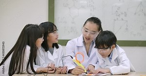 Asian teacher having 3d drawing lesson to elementary students in class. Science and education.