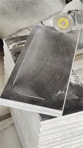 Skilled artisan uses rotary tool for intricate stone engraving