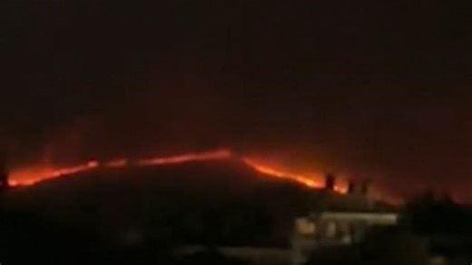Corfu's red horizon as wildfires creep in over the hills