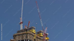 Cranes working on big constraction site works of new skyscraper timelapse. Urban development of high-rise tower and building activity