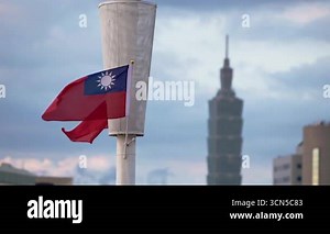 Taipei, Taiwan-14 October, 2024: Slow motion capture of the Taiwanese flag waving as Taipei 101 stands in the background, representing Taiwan's cultural identity amidst urban development Stock Video Footage - Alamy
