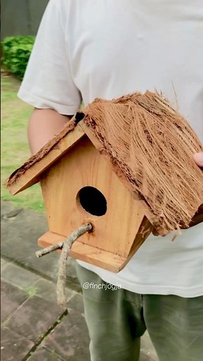 A simple wooden bird house built for nesting. Nature inspired design for small birds.