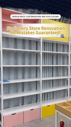 Stationery store competition is fierce — you need both aesthetics and functionality! This wall-mounted tall shelving features a steel-wood design, with white shelves paired with minimalist metal frames. Customizable in multiple colors to seamlessly blend with your store's interior decor! Freely adjustable shelves; the top can be fitted with light boxes or advertising KT boards to capture customers'attention. Large bottom drawers for hassle-free restocking! Snap-on assembly for quick and efficien
