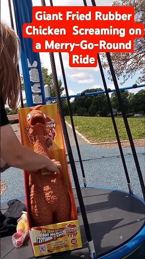 Giant fried rubber chicken screaming on a merry-go-round ride