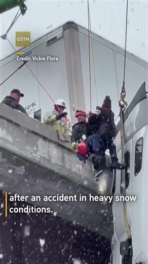 Driver rescued from dangling truck cab after snowy bridge accident in West Virginia