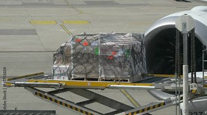 Professional video of unloading transport cargo from the airplane in 4K Slow motion 60fps