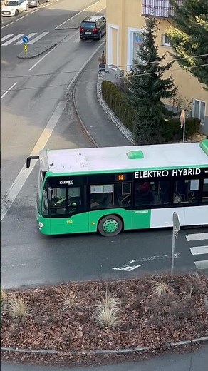 Who knows this BUS brand? Please answer. A view from the balcony #car #driving #peaple #society