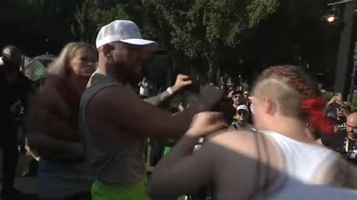 Conor McGregor stuck in the middle as punches fly during title fight face off