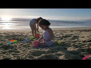 kids playing with sand at the beach