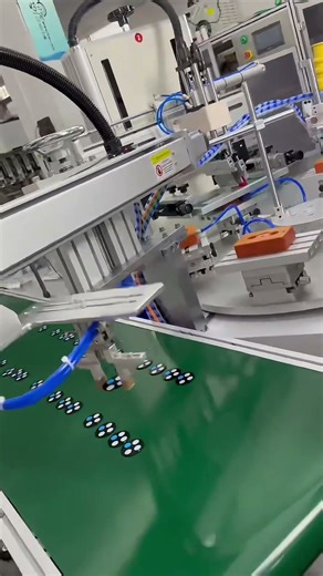 Automatic Screen Printer with 6-station indexing table and unloading manipulator.