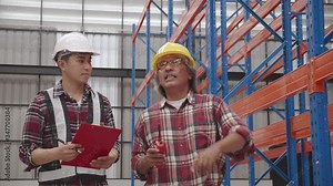 Asian Chief Engineer And contractors talking about work in construction factory or warehouses. Walk and check the structure of the building. Safety hard hat to wear while working Stock Video