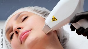 Close-up of a woman's face in a laser hair removal salon. A girl undergoes laser hair removal procedure on her face. Concept of removing unwanted hair.