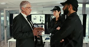 CCTV, security and supervisor talking to staff in office for instructions, meeting or surveillance. Communication, computer screen and manager person on control room to explain procedure or protocol