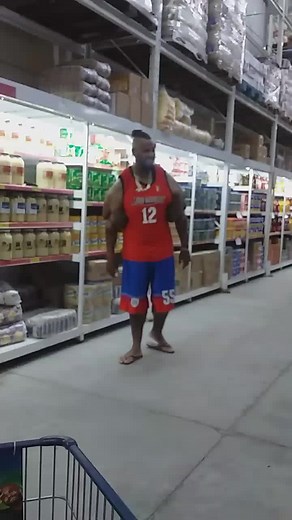 Muscular Man Flexing in Grocery Store Aisle