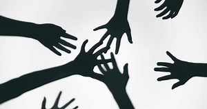 Shadow of a zombie hand on white background in slow motion