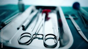 Medical instruments in steel tray on table for surgery. Preparing of surgical tools for a operation. Scalpels and forceps and tweezers. Surgery or emergency case and ambulance or treatment concept. Stock Video