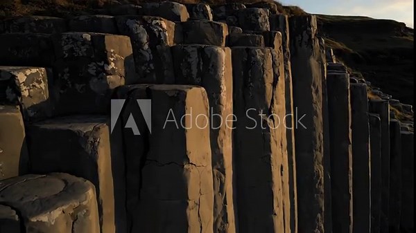 Basalt columns of natural rock formations at sunset for a geology and science documentary video footage Stock Video