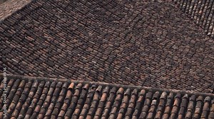 A close-up of tile shingles on a roof creating a textured background