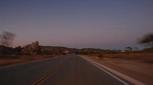 Download A time lapse drive down a desert highway at Dusk for free