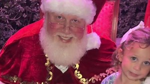 Santa Claus supports young girl who didn't want to sit on his lap