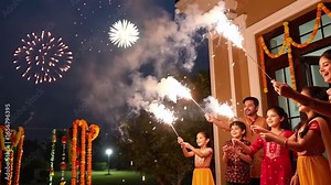 Diwali Festival Celebration with Family Lighting Sparklers
