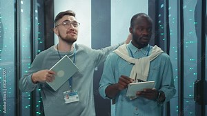 Expressive IT technician annoying his african partner with excessive talks nonsense in server room. Angry black specialist blowing up yelling at his colleague.