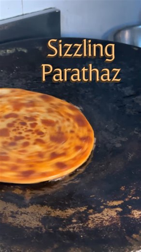 MJ & Subhi | Ahmedabad Food on Instagram: "This place in Ahmedabad serves tastiest Paraths at Prahlad Nagar. Follow the page @mastaana_mj & @sizzling_parathaz Sizzling, stuffed and anything but basic this paratha joint in Ahmedabad is serving fully loaded parathas with real filling and bold flavour in every bite. From classic aloo paratha to sizzling specials, zesty kadai paneer and fiery paneer variations, it’s the perfect spot for winter comfort food and late-night cravings. Save this reel if