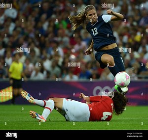 NO FILM, NO VIDEO, NO TV, NO DOCUMENTARY - USA's Alex Morgan (13) jumps over Japan's Saki Kumagai (4) in the second half of the women's soccer final at Wembley Stadium in London, UK, in the Summer Olympic Games on Thursday, August 9, 2012. The U.S. defeated Japan, 2-1, for the gold medal. Photo by Nhat V. Meyer/San Jose Mercury News/MCT/ABACAPRESS.COM Stock Photo - Alamy