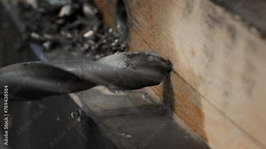 Spraying the coolant liquid on the industrial drilling equipment. Splashing the coolant on the drilling equipment to reduce the tool temperature. A Coolant liquid is poured on the drilling equipment.