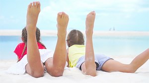 Adorable little girls at beach during summer vacation