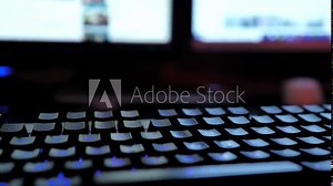 Glowing keyboard hackier style glittering at the night workplace with different light colors Stock Video