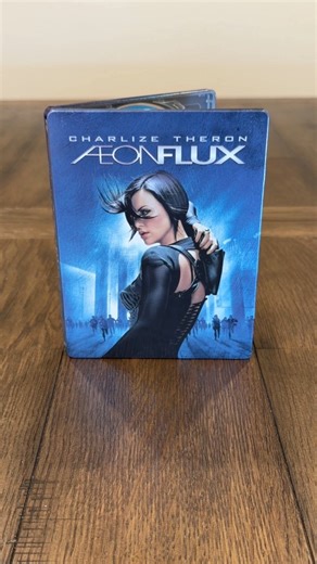 ÆON FLUX - 20th Anniversary Limited Edition Steelbook | 4KUHD Blu-ray Digital Code | (Available 10/21) SPECIAL FEATURES: • Commentary by Charlize Theron and Producer Gale Anne Hurd • Commentary by Co-Screenwriters Phil Hay and Matt Manfredi • Creating a World: Aeon Flux • The Locations of Aeon Flux • The Stunts of Aeon Flux The Costume Design Workshop of Aeon Flux • The Craft of the Set Photographer on Aeon Flux #aeonflux #ÆONFLUX #steelbook #4KUHD #bluray #physicalmedia #collector | One Minute 