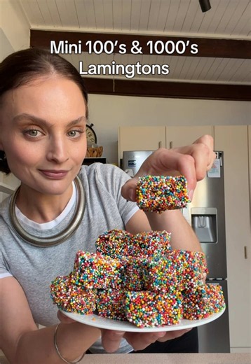 Mini 100s & 1000s Lamingtons: Vanilla Cake: 125g butter, softened 1 cup caster sugar 2 eggs ¼ cup sour cream 1 tsp vanilla 2 cups self-raising flour Pinch of salt ½ cup milk Chocolate Coating: 3 cups icing sugar ⅓ cup cocoa powder 30g butter, softened ½ cup boiling water To Finish: 100s & 1000s (2 x 190g bags) Method: Preheat oven to 170°C fan-forced and line a 10 x 10 inch (25 x 25cm) square cake tin. Beat the butter and caster sugar until light and fluffy. Add the eggs one at a time, then mix 