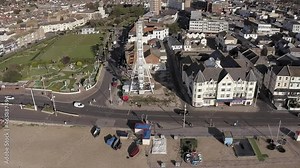 Bognor Regis aerial footage along the seafront with fishing boats and observation wheel in view next to Waterloo Square at this popular tourist destination in Southern England.