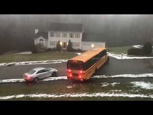 School bus full of children slides down icy street, slams into car