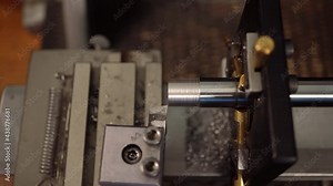 Thread cutting with oil lubrication. machine metalworking. Screw-thread. Automated Process at the Modern Steel Manufacture Plant. Metal screw at grommet production line.