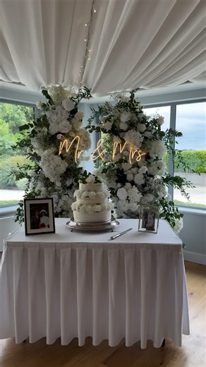 Faux Floral Rental | Wedding Stylist on Instagram: "Classic florals for this beautiful wedding at @killeavycastle The recipe for the ultimate wedding reception: - Top table bursting with blooms - Guest table floral centrepieces - Table runners to add colour and texture - Modern table numbers - candles on all tables - Neon floral backdrop for photos - Modern welcome sign - matching table plan - Card box Contact us for more information on our floral & styling packages. Anna@bloomingeventsni.com or